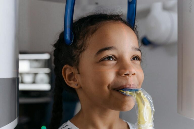Young child receiving a dental X-ray with protective lead apron