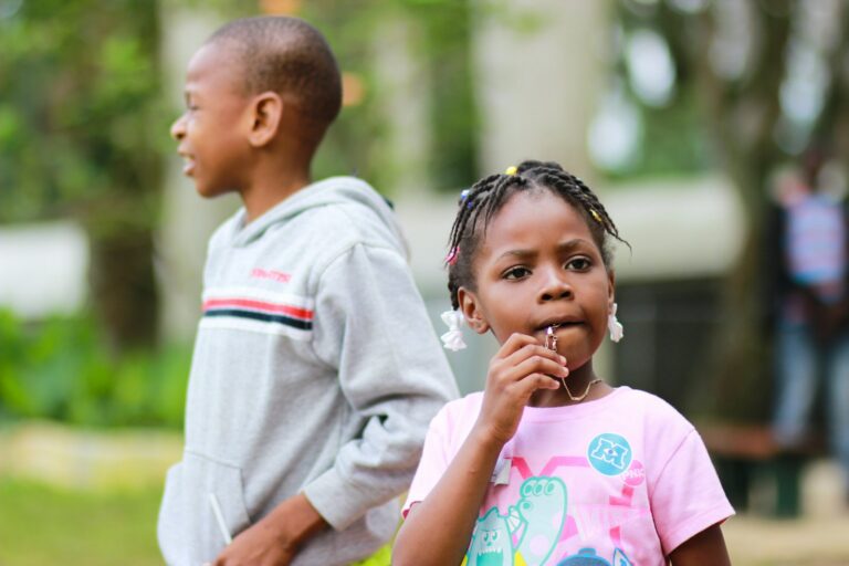 Worried parent smelling child’s breath after brushing teeth