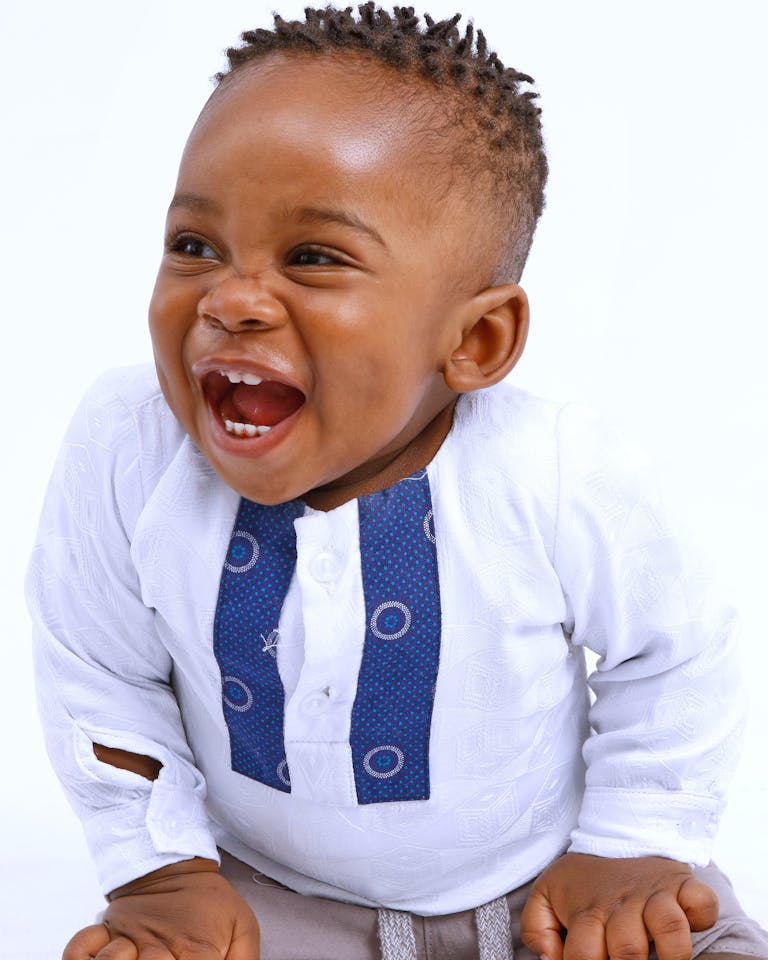 Child holding a baby tooth that just fell out naturally