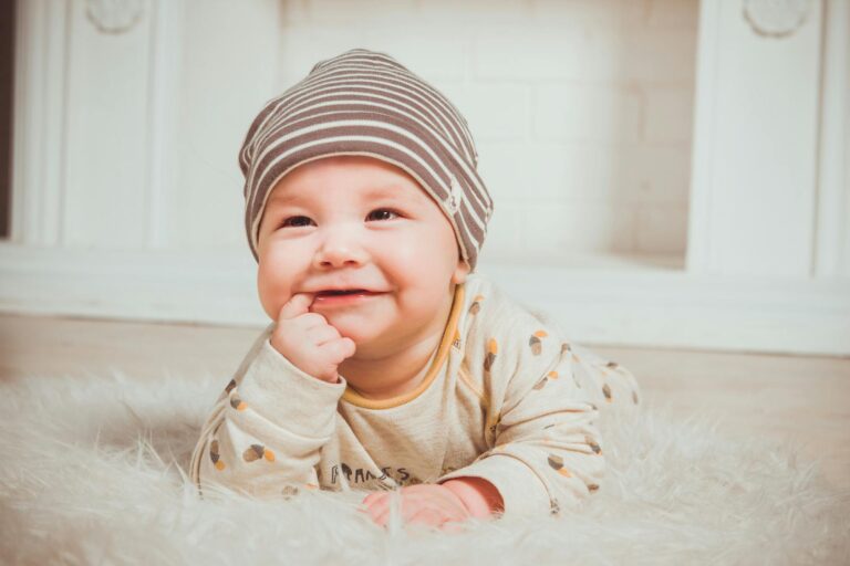 Parent gently cleaning baby’s gums with a soft, damp cloth