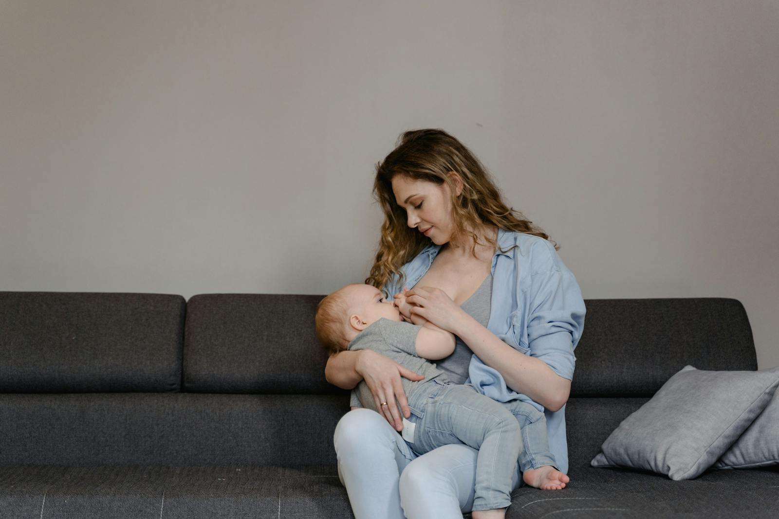 Mother breastfeeding baby at night while the child is falling asleep