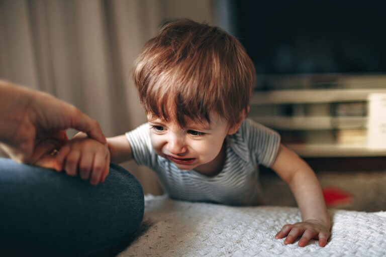 Parent comforting a child after a knocked-out baby tooth incident