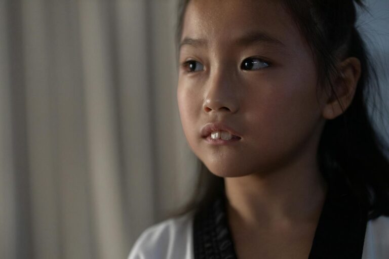 Child with visibly swollen gums receiving care at home